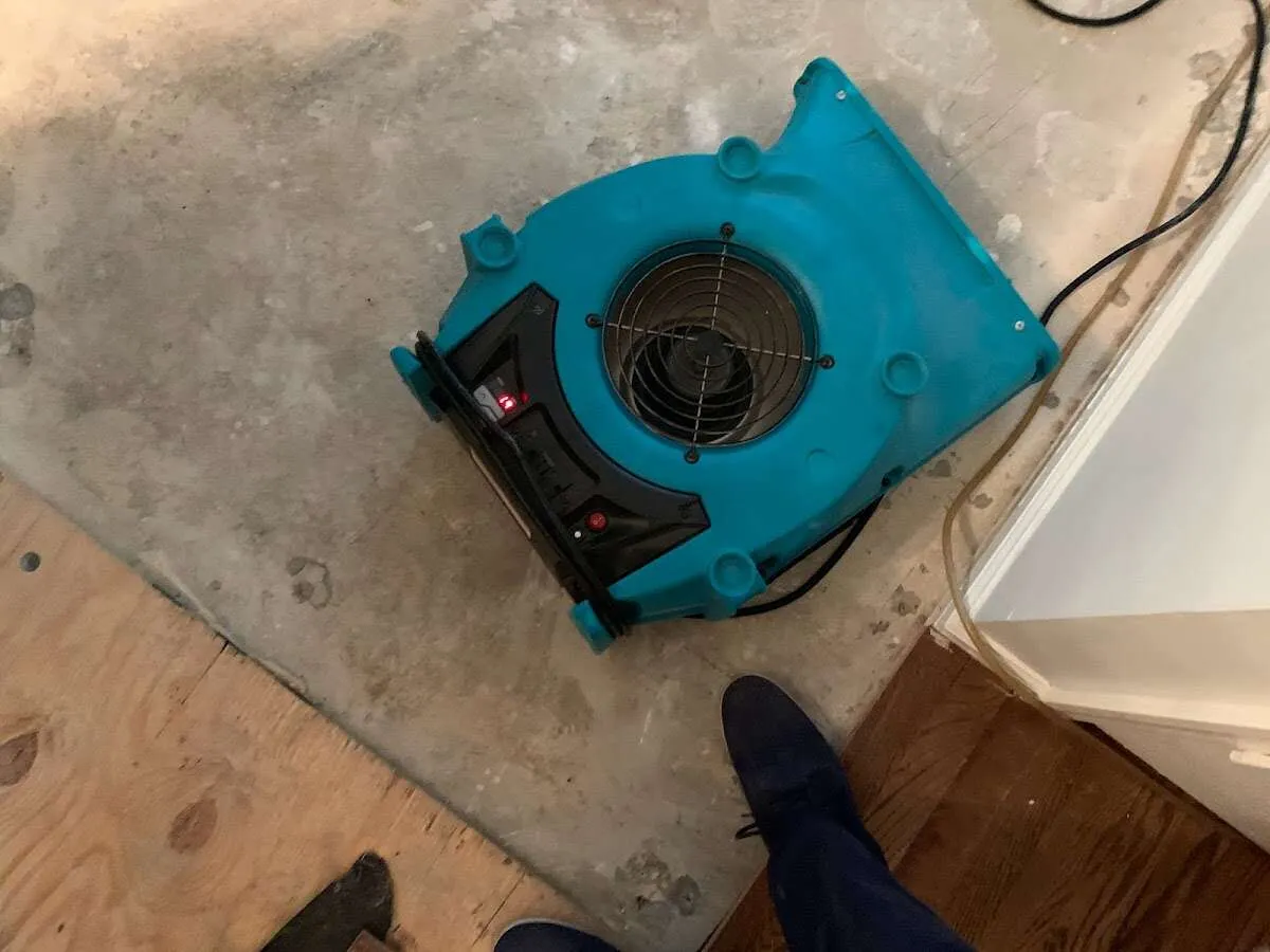 Air mover drying subfloor during Leak Detection & Repair in McFarland